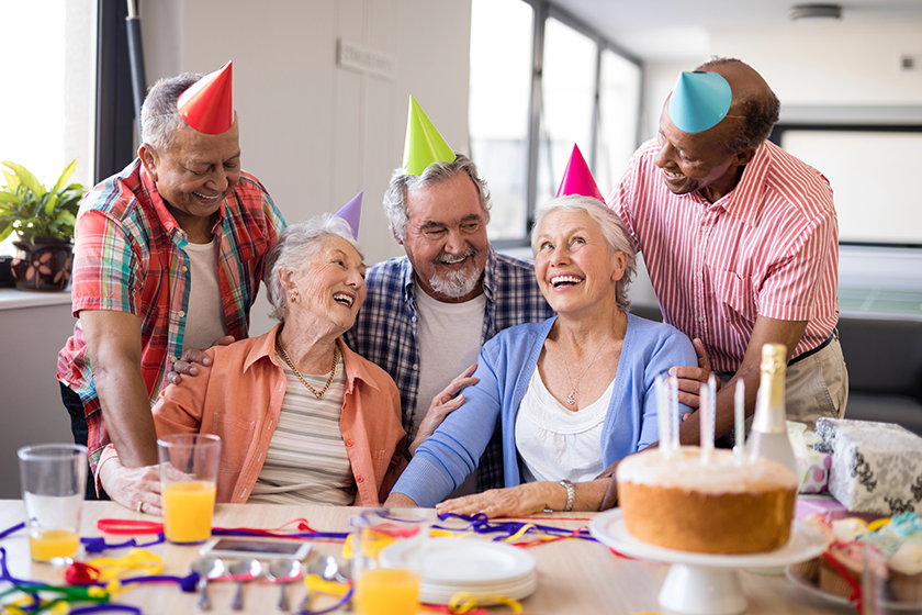 Cheerful friends looking at excited senior woman