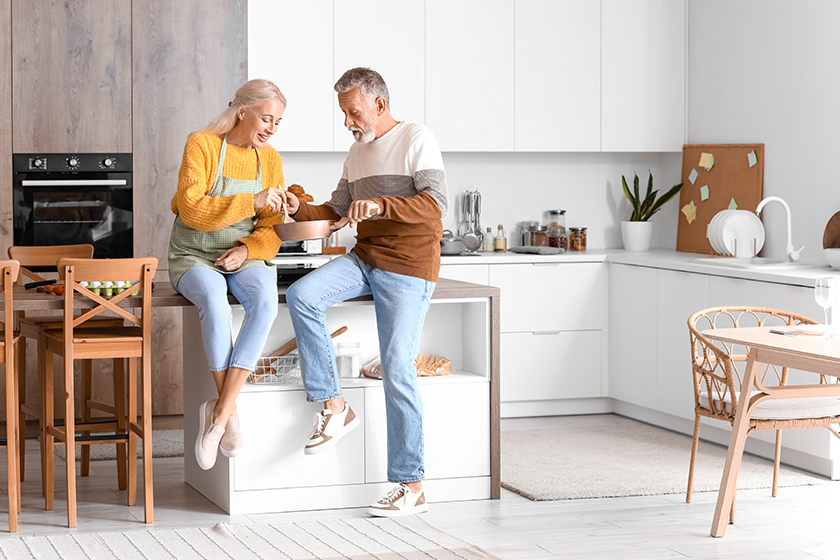 Mature couple eating in kitchen