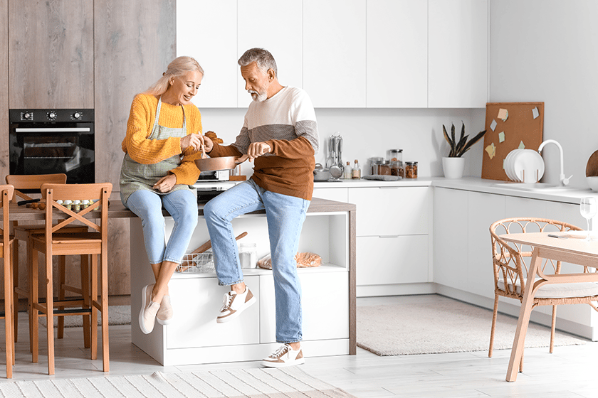 Mature couple eating in kitchen