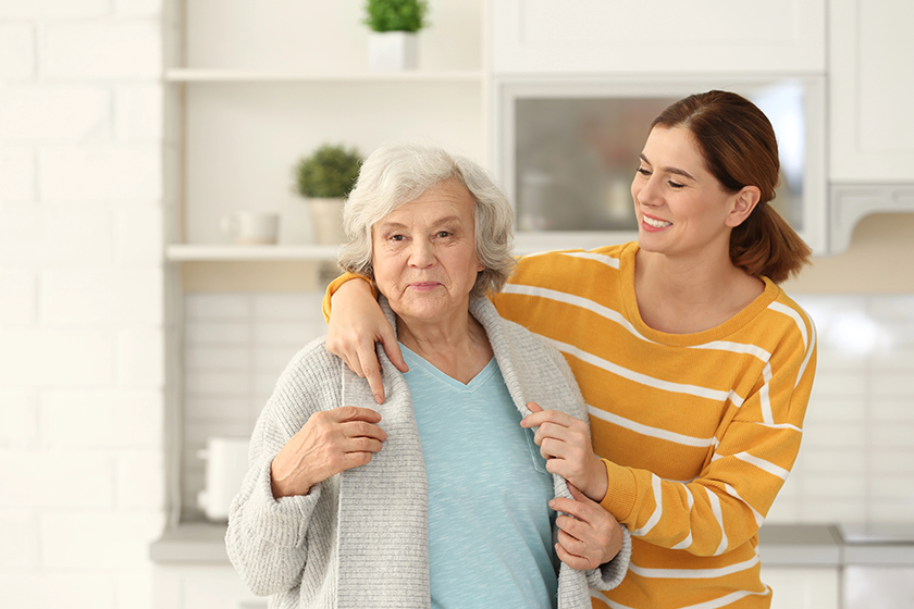 Elderly woman with female caregiver in kitchen