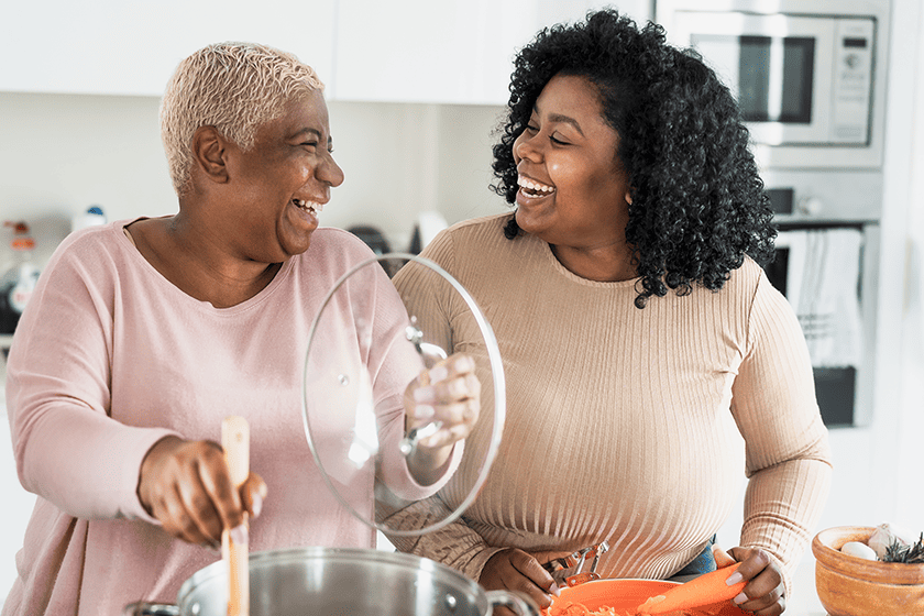 happy afro mother daughter preparing lunch together